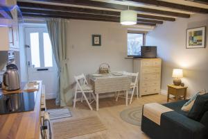 a living room with a table and a dining room at Little Thornsett in Buxton