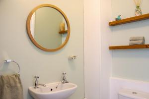 a bathroom with a sink and a mirror on the wall at Little Thornsett in Buxton