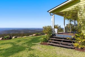 a house on a hill with a porch and stairs at The Quince Cottage - 2 Bedrooms in Ravensbourne