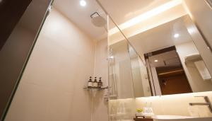 a bathroom with a shower and a mirror at Kwangsu Hotel Haeundae in Busan +84 photos