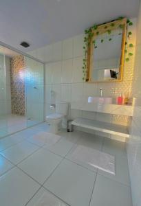 a bathroom with a toilet and a sink and a mirror at Lar dos Lençóis in Barreirinhas +19 photos