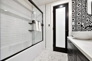 a bathroom with a sink and a glass shower at Peak View Guesthouse - Walk to Garden of the Gods - Hot Tub - Epic Views! in Colorado Springs +62 photos