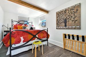 a bedroom with a bed and a wooden crib at Peak View Guesthouse - Walk to Garden of the Gods - Hot Tub - Epic Views! in Colorado Springs