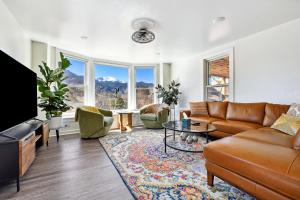 a living room with a couch and a table at Peak View Guesthouse - Walk to Garden of the Gods - Hot Tub - Epic Views! in Colorado Springs