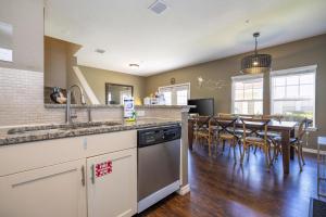 a kitchen and dining room with a table and chairs at Villa Hakuna Matata- Lucaya Village Resort in Kissimmee