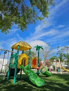 a playground in a park with a slide at Private Canarian house with pool in Conkal