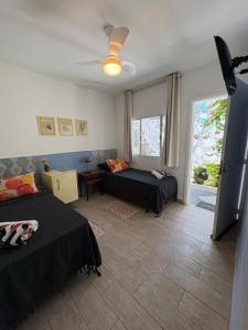 Ένα ή περισσότερα κρεβάτια σε δωμάτιο στο Buona Notte Hostel & Pousada