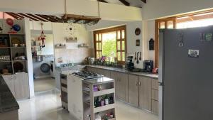 a large kitchen with a stove and a refrigerator at Casa campestre Montenegro Quindio in Montenegro