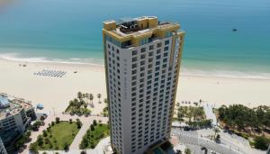 a tall building with a beach in the background at Kwangsu Hotel Haeundae in Busan