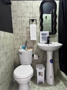 a bathroom with a toilet and a sink at Chinuk Boutique Hotel in Puerto Viejo +80 photos