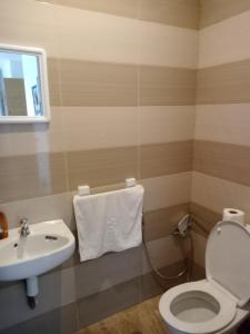 a bathroom with a toilet and a sink at Appart 3p vue sur mer in Rabat +7 photos
