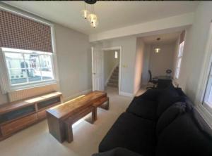 a living room with a couch and a window at Two bed town house in Royal Leamington Spa in Leamington Spa