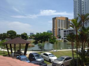 a parking lot with cars parked next to a river at Get 2 HomeStay in Melaka