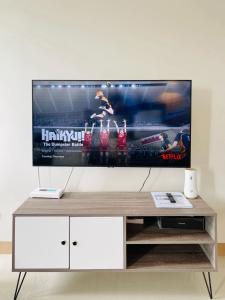 a flat screen tv sitting on top of a white entertainment center at Elegant Style Studio in SMDC in Cari Mayor +9 photos