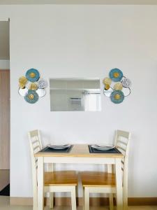 a dining room table with two chairs and a mirror at Elegant Style Studio in SMDC in Cari Mayor