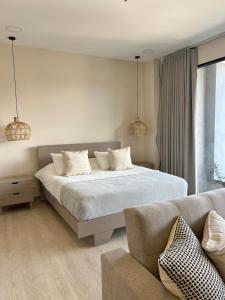 Giường trong phòng chung tại Hermoso apartamento en el poblado