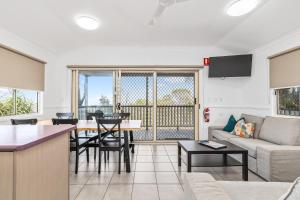 a living room with a couch and a table at BIG4 Lake Maraboon Holiday Village in Gindie