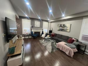 a living room with a couch and a fireplace at Luxury 5BR Home with Spa Bath in Burlington