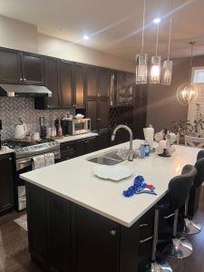 a kitchen with a kitchen island with a sink in it at Luxury 5BR Home with Spa Bath in Burlington