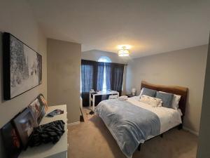 a bedroom with a large bed and a window at Luxury 5BR Home with Spa Bath in Burlington