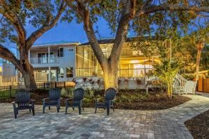 a group of chairs sitting in front of a house at Villa Champagne - 5322 in Siesta Key