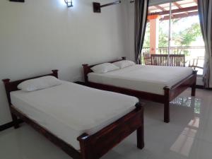 Katil atau katil-katil dalam bilik di Man Guest Polonnaruwa