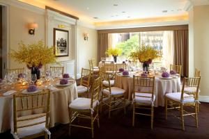 a room with long tables and chairs with flowers at Trump International New York in New York +37 photos