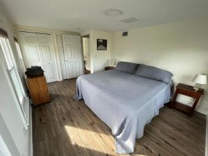 a bedroom with a bed and two white doors at Old Florida Charm in Eustis +11 photos