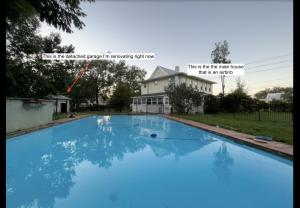 a large blue swimming pool in front of a house at Old Florida Charm in Eustis