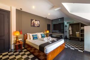 a bedroom with a bed and a checkered floor at Baby Elephant Boutique Hotel in Siem Reap +123 photos