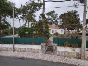 a fence in front of a house at Classic 3BR Sintra Home near Beaches & Palaces in Colares