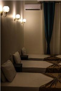 a hotel room with two beds and a window at The Egyptian apartment in Cairo