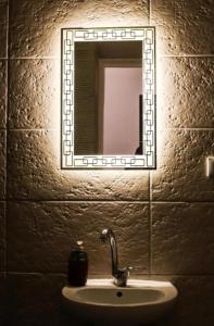 a bathroom sink with a mirror on a wall at The Egyptian apartment in Cairo