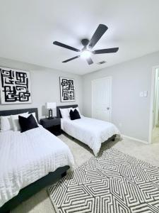 a bedroom with two beds and a ceiling fan at Spacious Centrally Located with Heated Pool in Frisco +34 photos