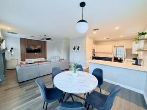 a kitchen and a living room with a table and chairs at Spacious Centrally Located with Heated Pool in Frisco