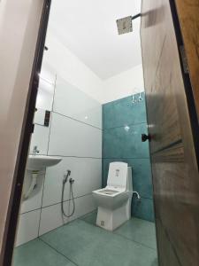 a bathroom with a toilet and a sink at Urban villa in Trivandrum