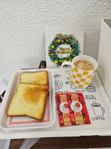 a tray with a plate of toast and a cup of coffee at 목포 달달마실 게스트하우스 in Mokpo +15 photos