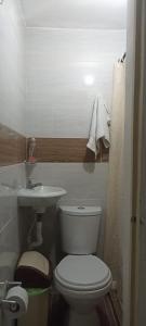 a bathroom with a white toilet and a sink at My second house in Manizales