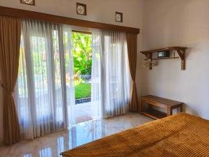Ένα ή περισσότερα κρεβάτια σε δωμάτιο στο Ayanta Bali Homestay