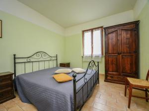 a bedroom with a bed and a wooden door at Mansion in Apecchio with Pool in Apecchio