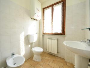 a bathroom with a white toilet and a sink at Mansion in Apecchio with Pool in Apecchio +29 photos
