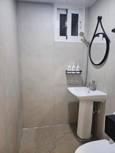 a bathroom with a shower and a sink and a mirror at 목포 달달마실 게스트하우스 in Mokpo