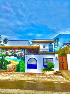 a house with a mural on the side of it at Dốc Biển Homestay Mui Ne in Ấp Khánh Phước (1)