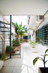 an internal courtyard of a building with potted plants at Travelero Hostel & Tours in Santa Cruz de la Sierra