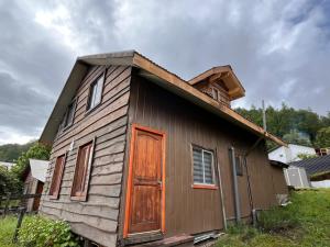 a small wooden house with a pitched roof at Cabañas Amancay Fuy in Puerto Fuy