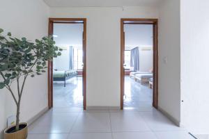 a hallway with two doors and a potted plant at Family Home with Private Pool in Guadalajara