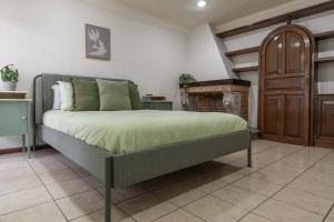 a bedroom with a bed and a fireplace at Family Home with Private Pool in Guadalajara +53 photos