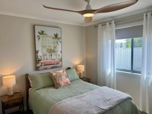 a bedroom with a bed with a ceiling fan at Solmar Siesta - WiFi Pet Friendly Outside in Robe