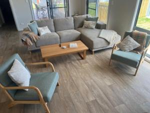a living room with a couch and two chairs and a table at Solmar Siesta - WiFi Pet Friendly Outside in Robe