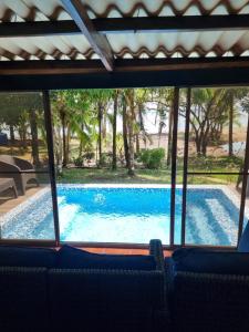 a view of a swimming pool through a window at Bio-Cébaco Cabañas in Isla Cebaco 